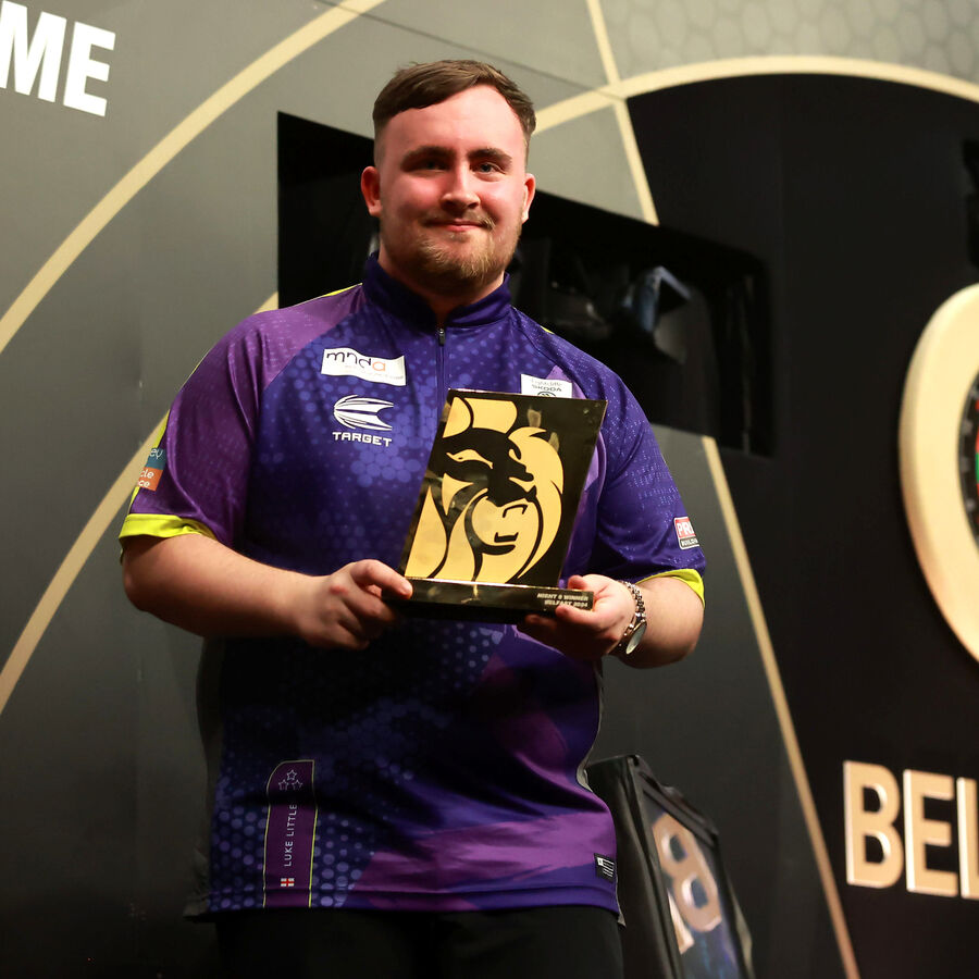 Luke Littler celebrates with the trophy after victory in the final against Nathan Aspinall