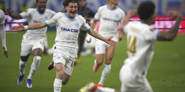 Marseille players celebrate after winning a penalty shootout at the end of the Europa League quarter final second leg 