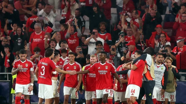 Benfica players celebrate after Orkun Kokcu scores their fourth goal