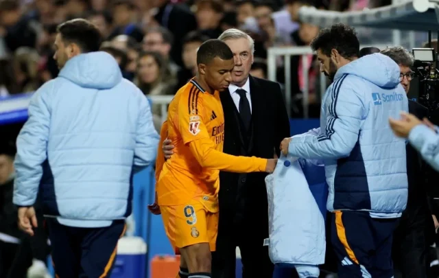 Real Madrid's Kylian Mbappe with coach Carlo Ancelotti after being substituted