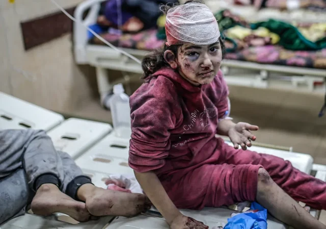 Photos show young children covered in blood and mud under rubble