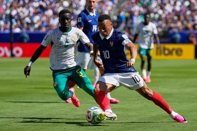 France's Kylian Mbappe tries to dribble the ball past Senegal's Idrissa Gana Gueye, left, during the World Cup Group I soccer match between France and Senegal in East Rutherford, N.J., near New York, Tuesday, June 16, 2026. AP Photo/Yuki Iwamura