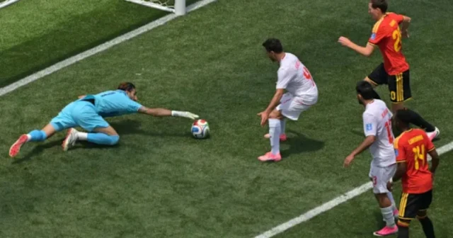 Iran goalkeeper Alireza Beiranvand (1) saves during the World Cup Group G soccer match between Belgium and Iran in Inglewood, Calif., near Los Angeles, Sunday, June 21, 2026. (AP Photo/Jayne..